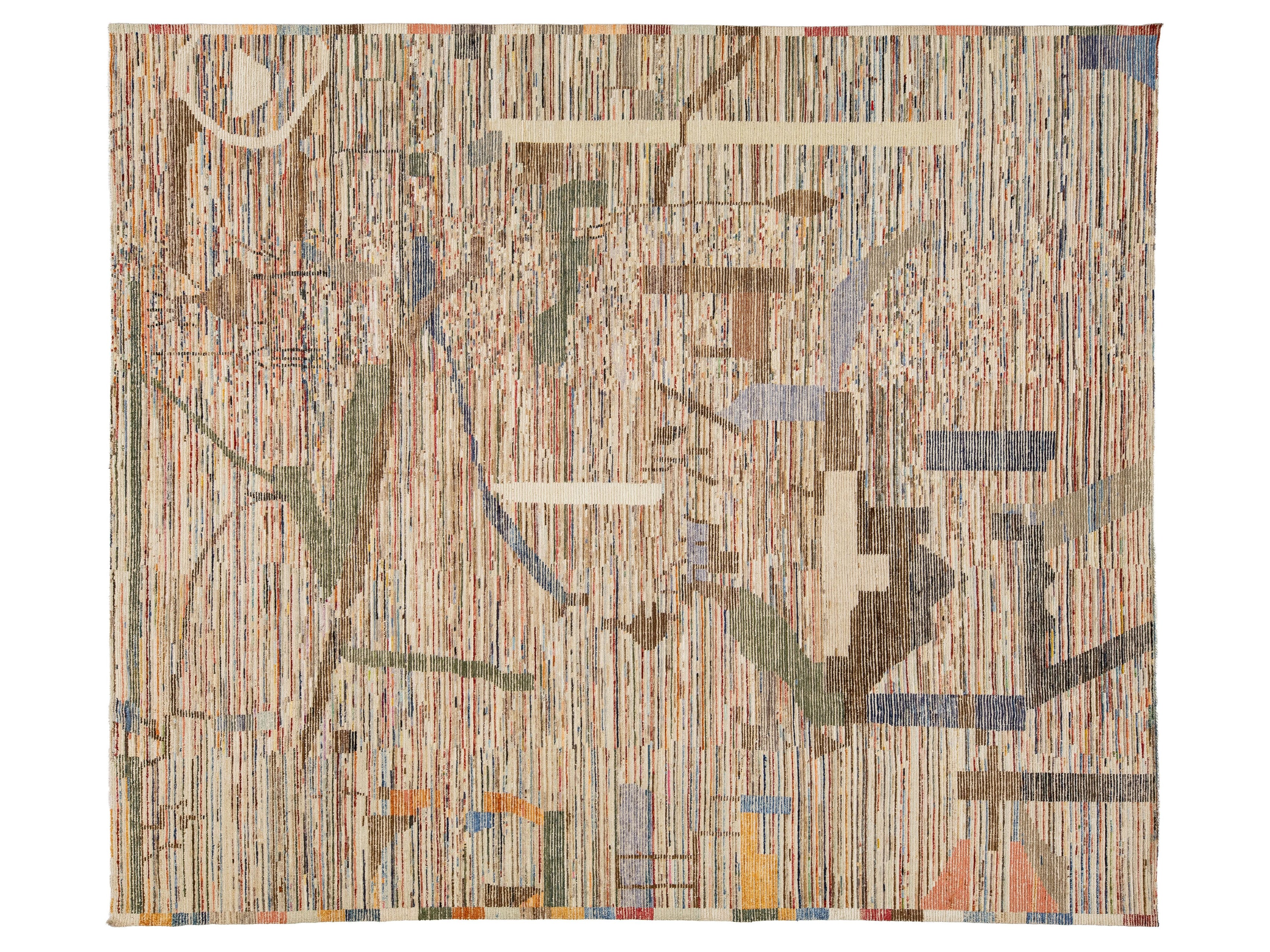 An abstract woven textile or rug featuring vertical striped patterns in beige, brown, and muted blue, with scattered geometric accents in cream, green, orange, and red.