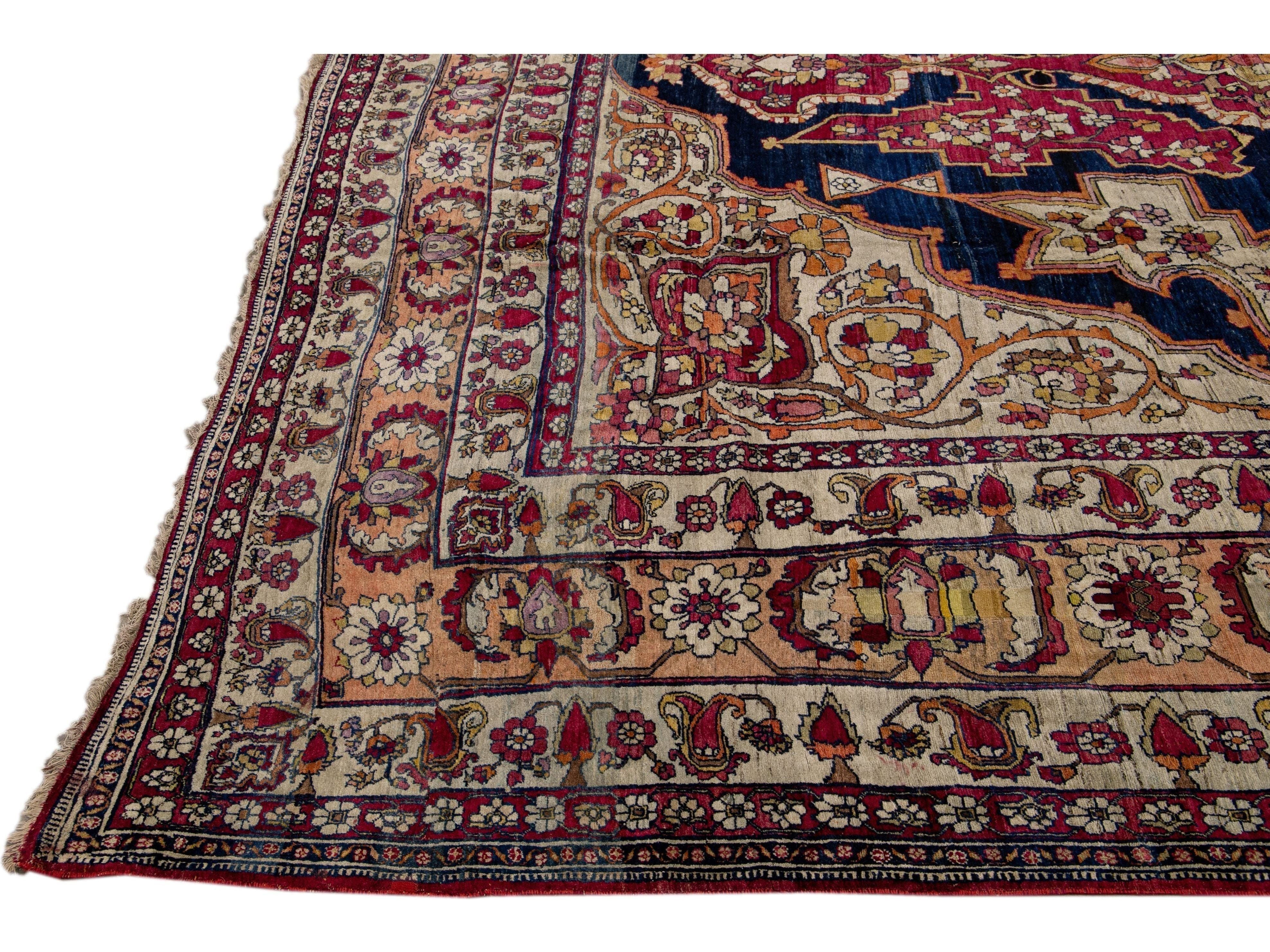 Antique Kerman Handmade Red and Blue Floral Medallion Motif Wool Rug